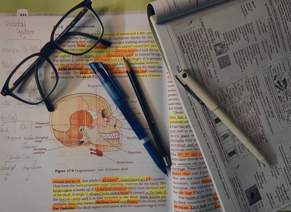 Study materials and reference textbook used to prepare for an allied health certification exam
